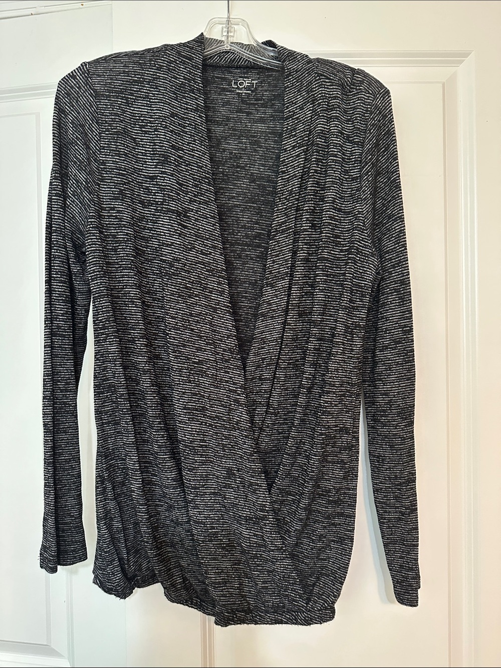 Loft size Medium gray and black striped Loft crossover top with long sleeves.